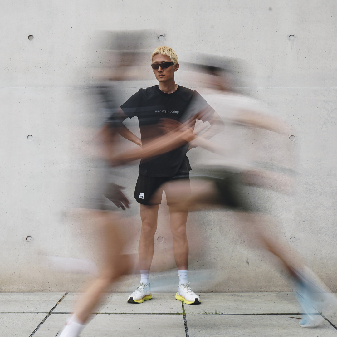 a runner standing still while others blur past